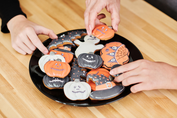 People Take Halloween Cookies from Plate